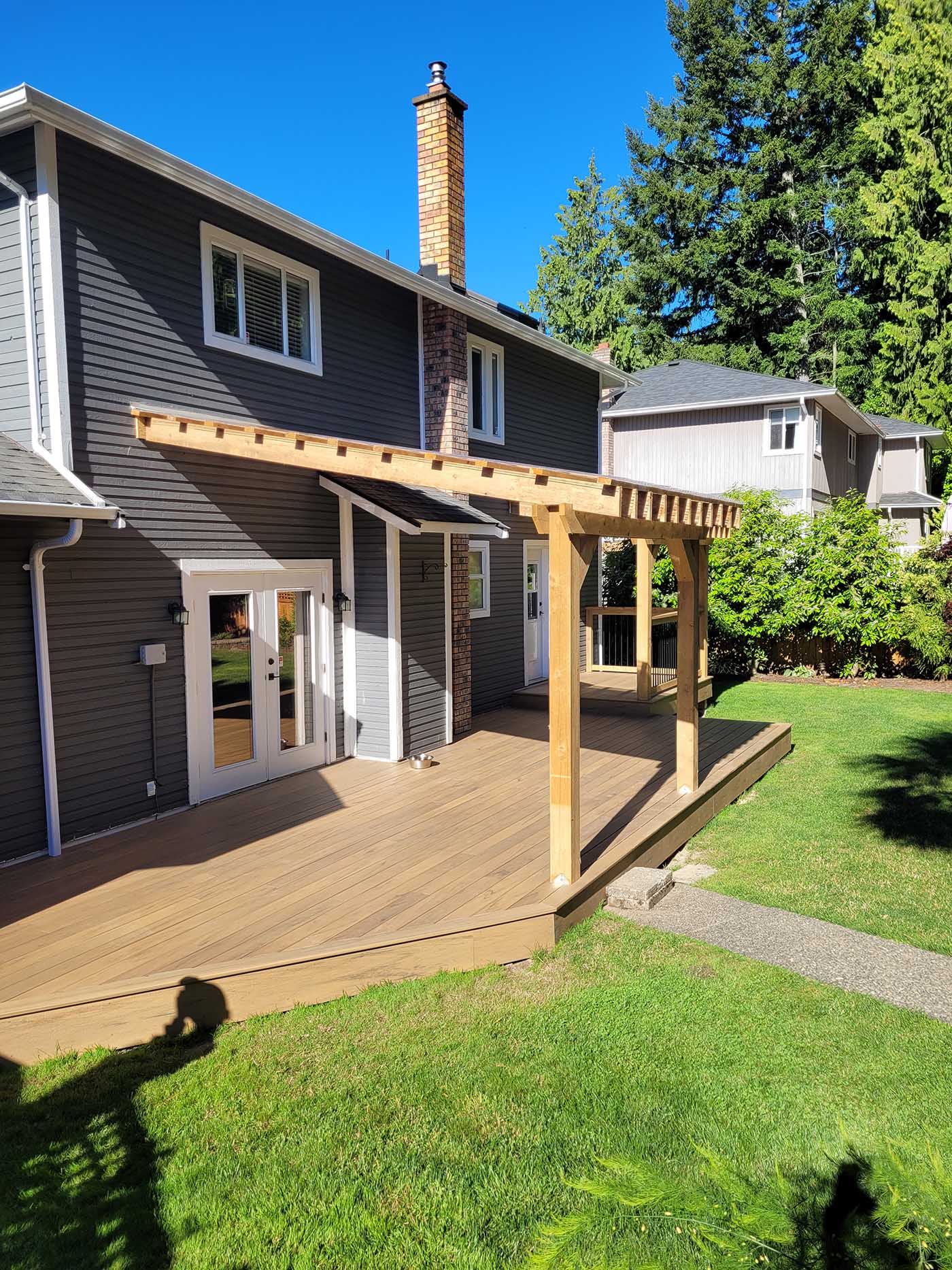 Wooden deck with pergola, sunny day