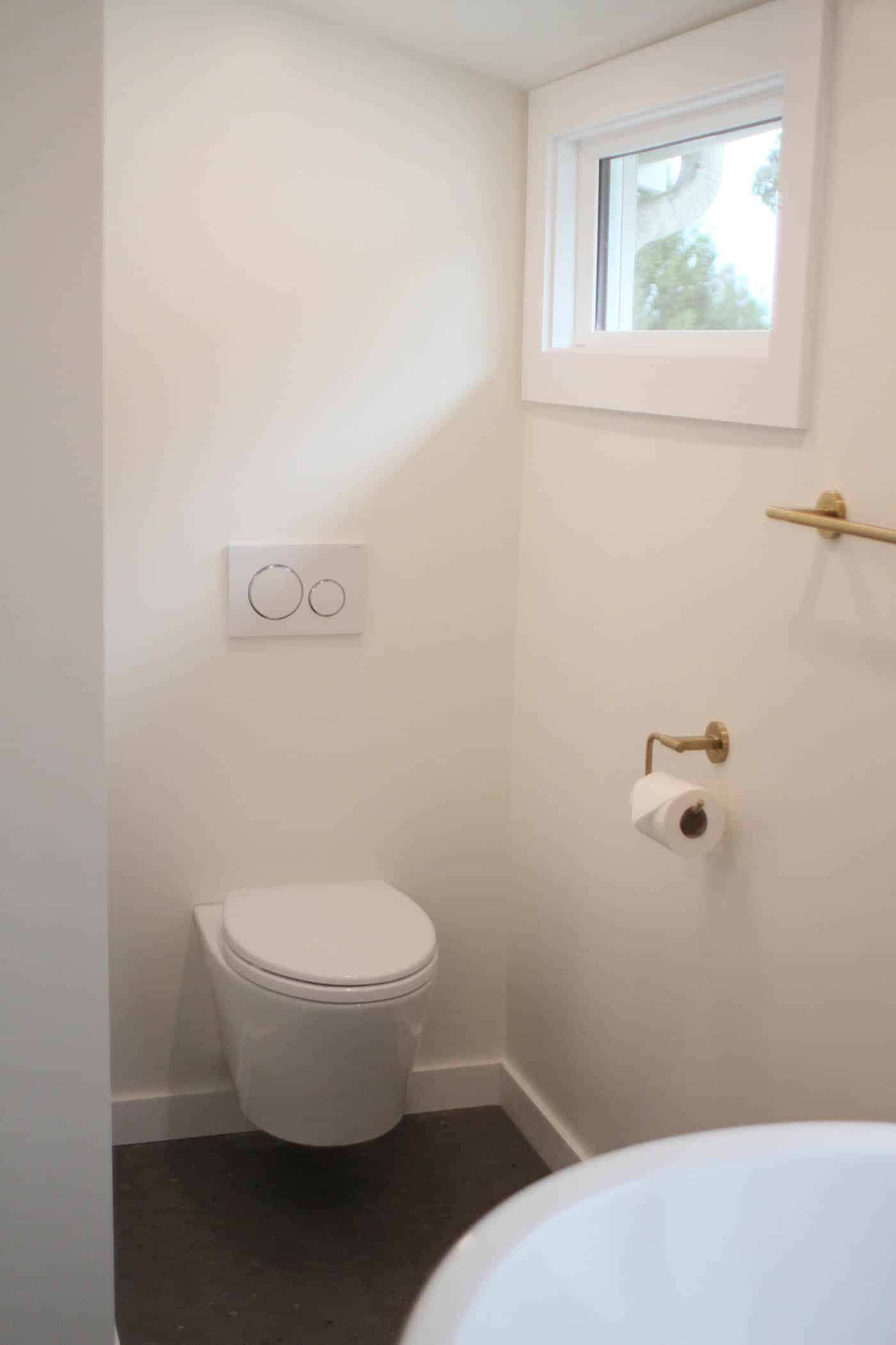 Minimalist bathroom with toilet and window