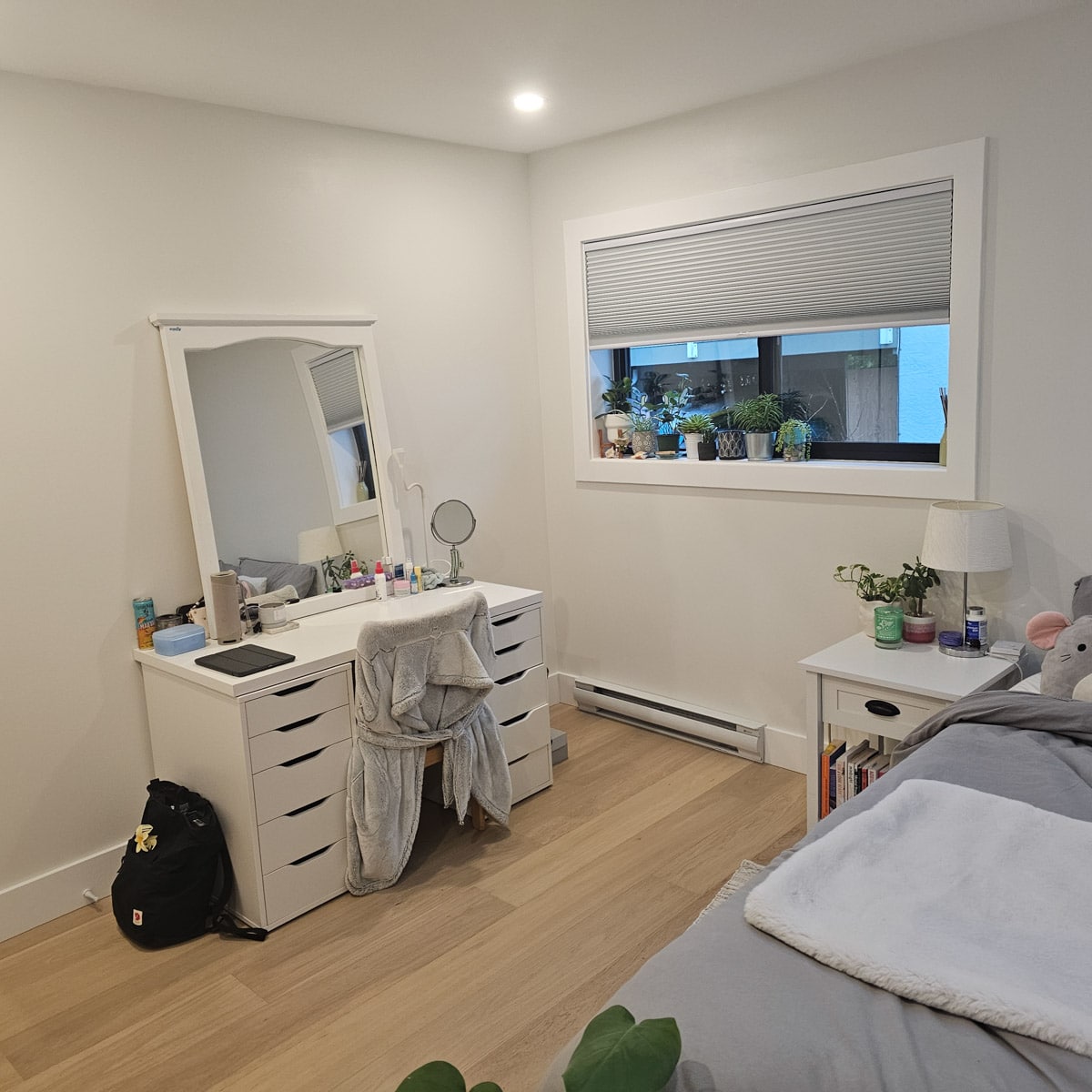 Bright, minimalist bedroom with vanity.